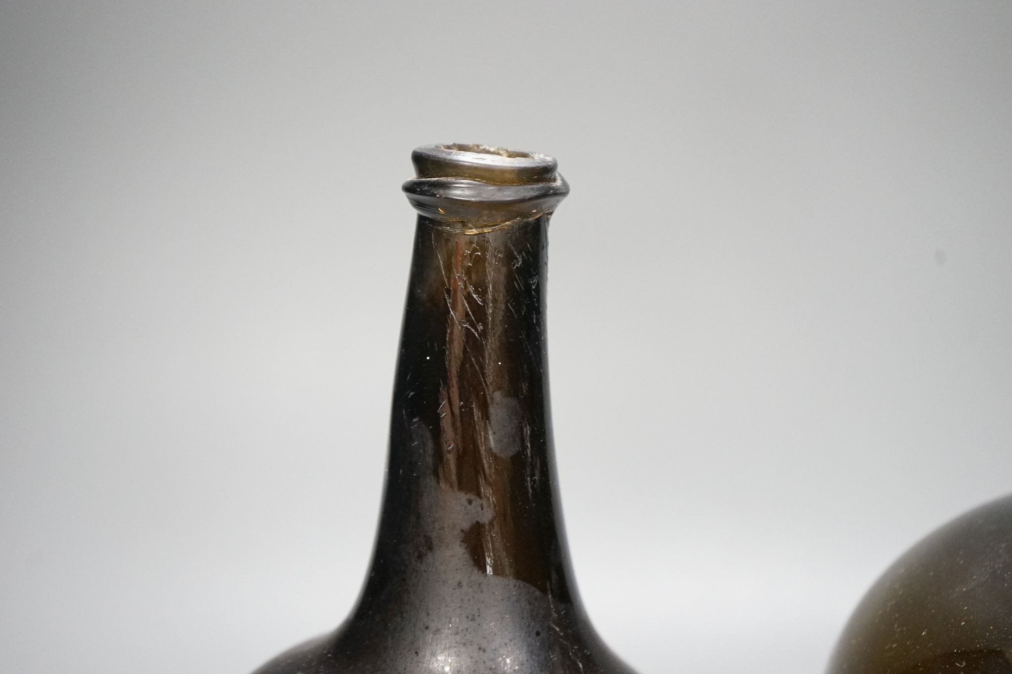 Two mid 18th century glass mallet-shape wine bottles, tallest 27cm